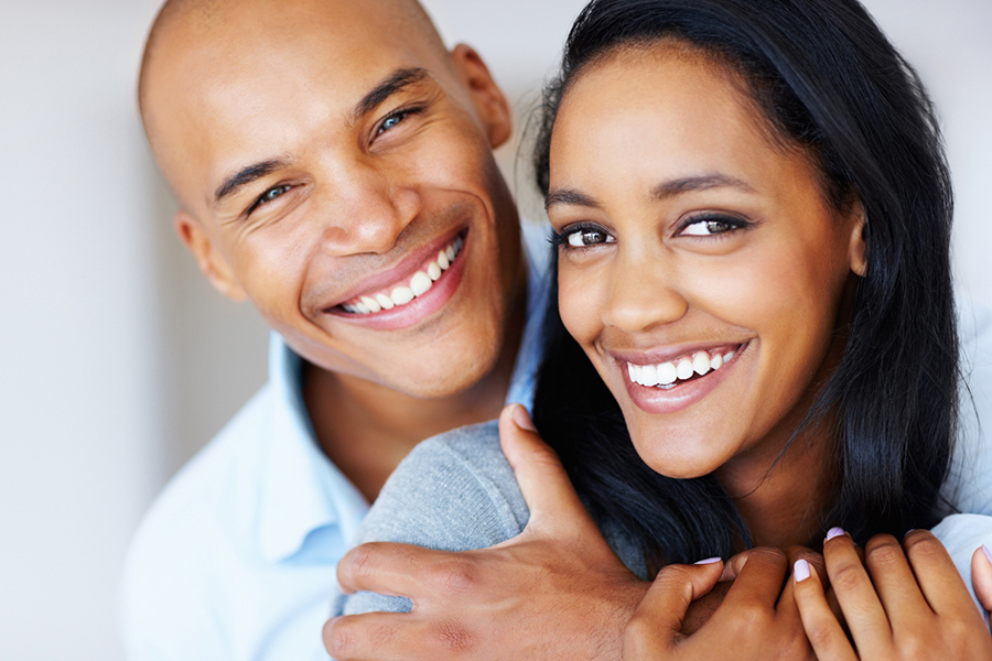 Closeup of beautiful young woman being embrace by her boyfriend - copyspace