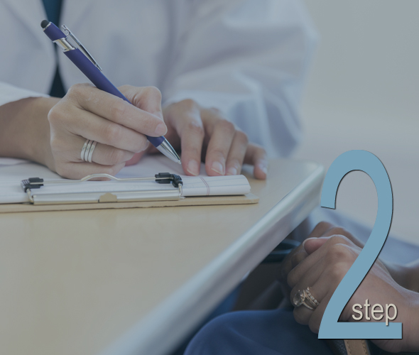 Unrecognizable female doctor discusses a female patients test results. She is writing in the patient's medical chart.